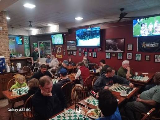 Players of all ages, including kids, competing in the weekly chess tournament at Boomerjack's in Katy, Texas