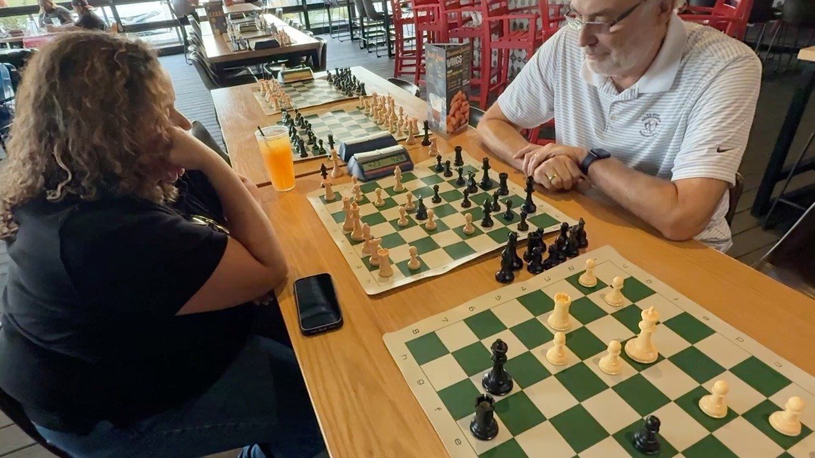 Two players concentrating over a chess game