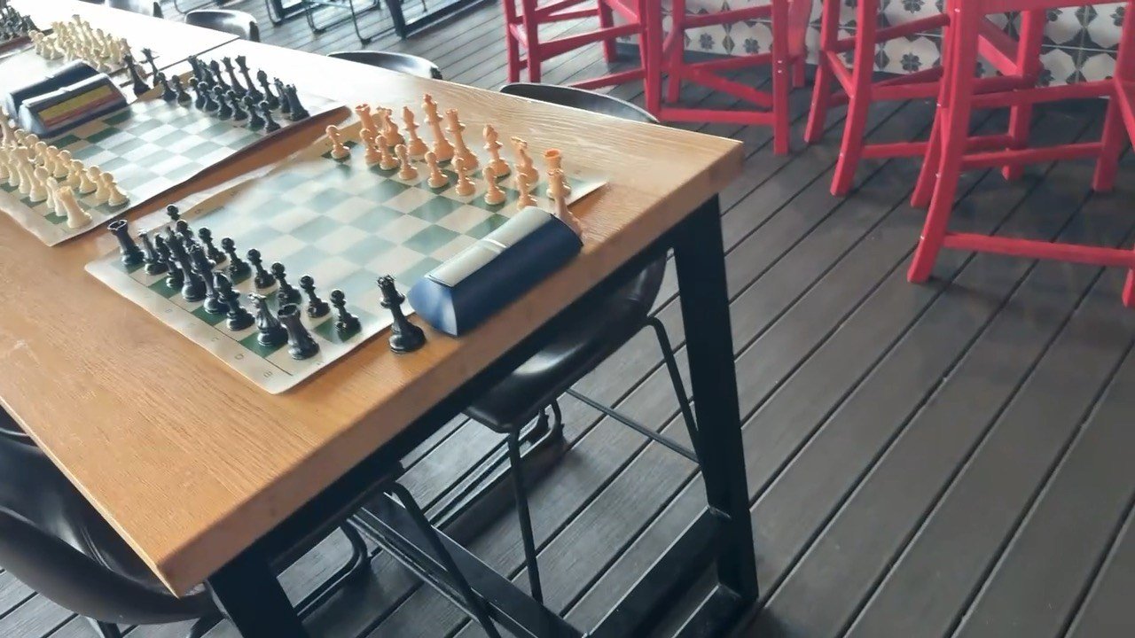 An empty chess board set up and waiting for players