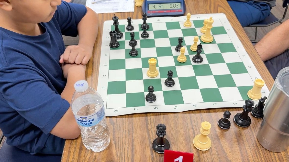 Late-game position on Board 1 with the clocks running low