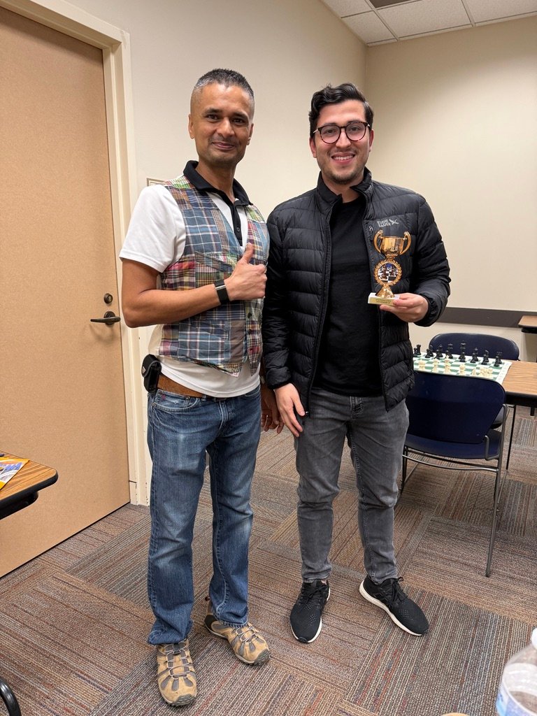 Jay gives a thumbs up standing next to champion David and his trophy