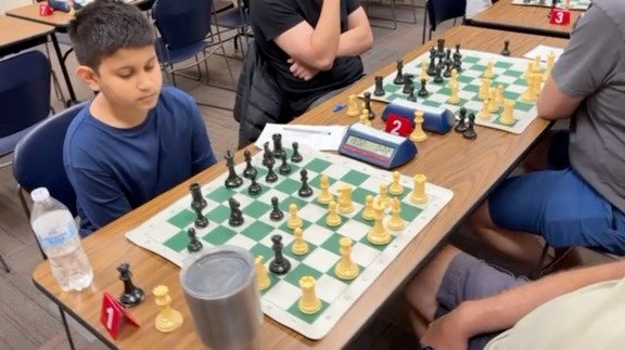 A junior player focused on his game at Board 1
